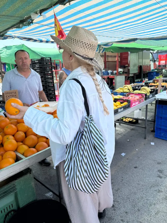 The striped tote in everyday use at a market